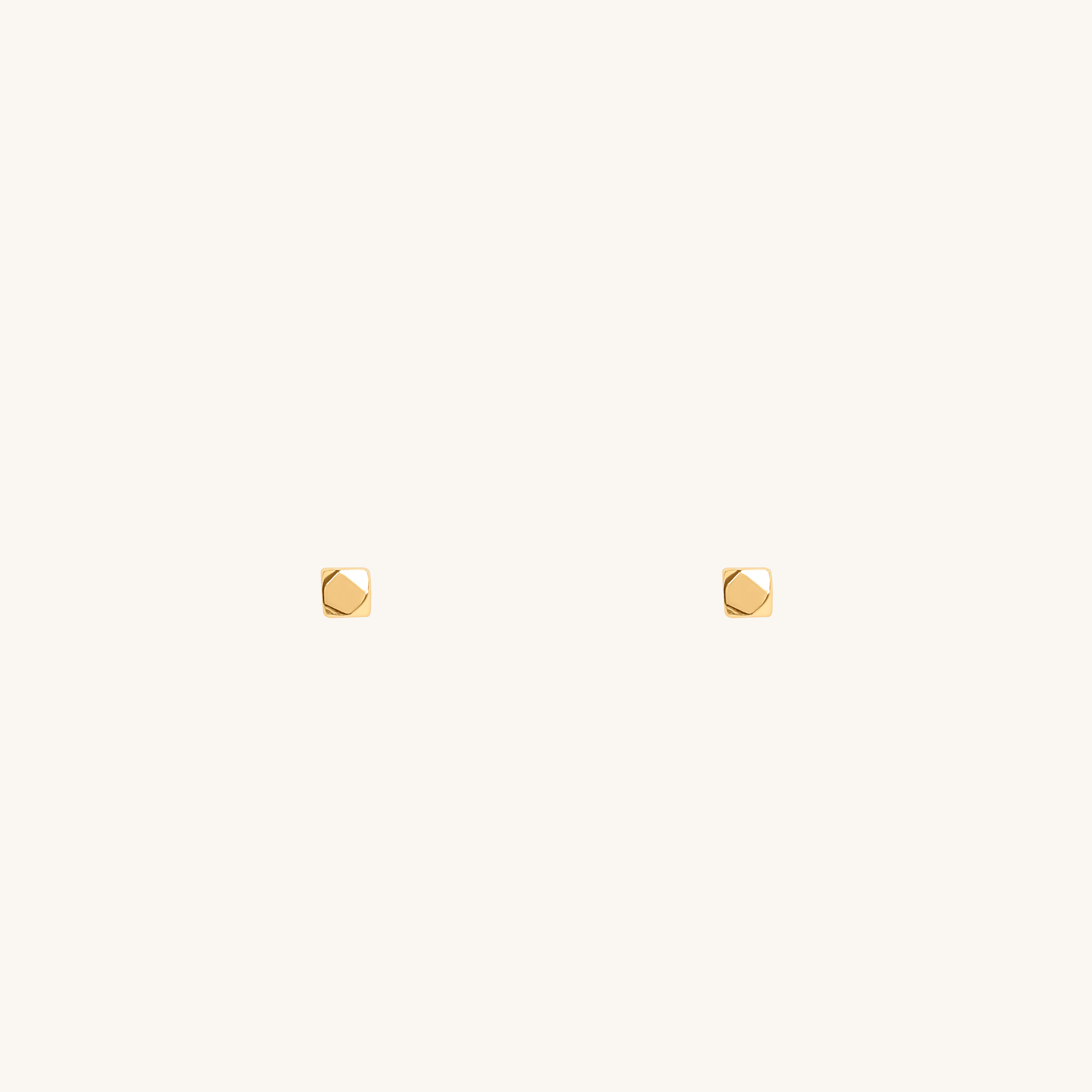 Pair of Righteousness small earrings in 18K gold displayed on an off-white background.