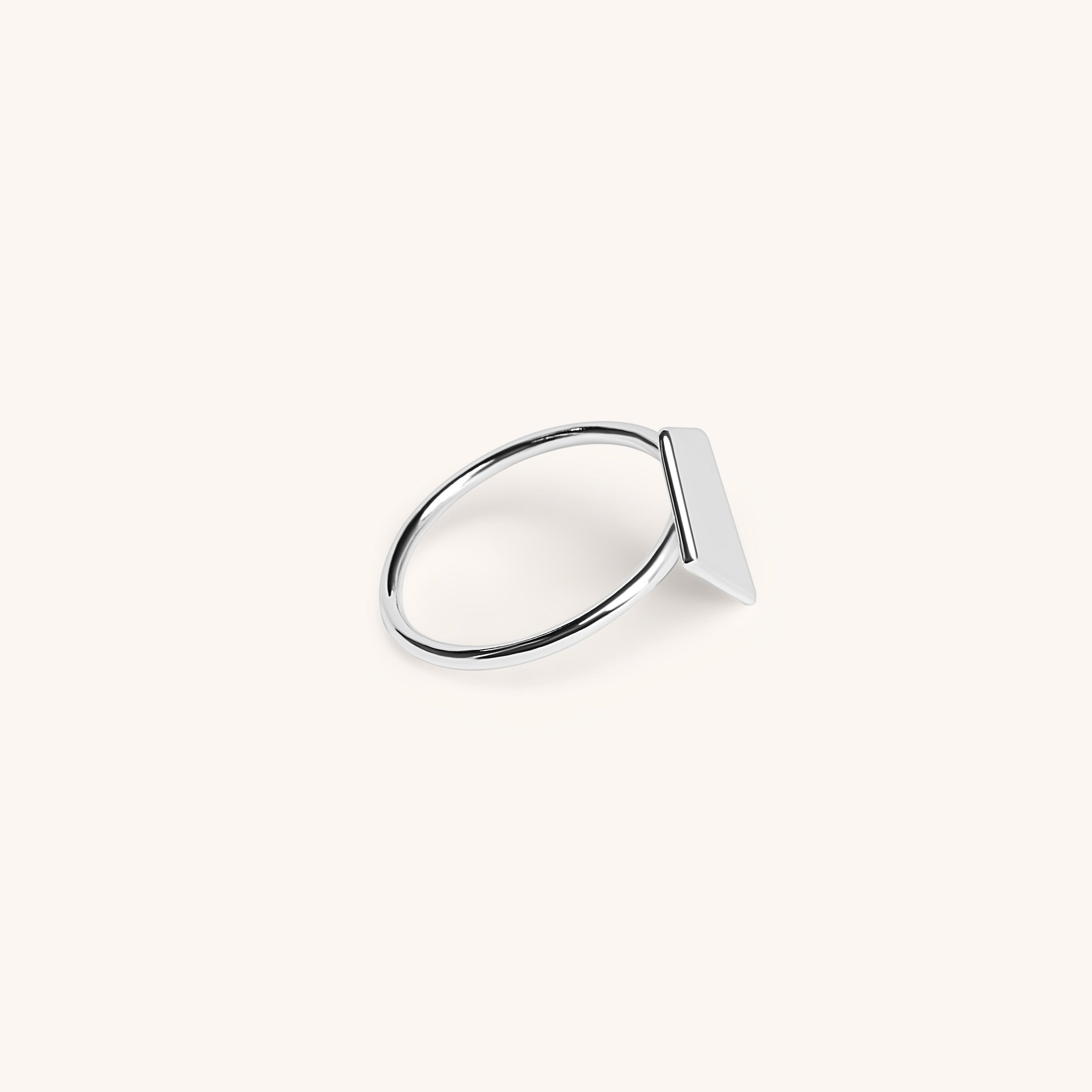 Shield of Faith Ring 18K White Gold side view on an off-white background.