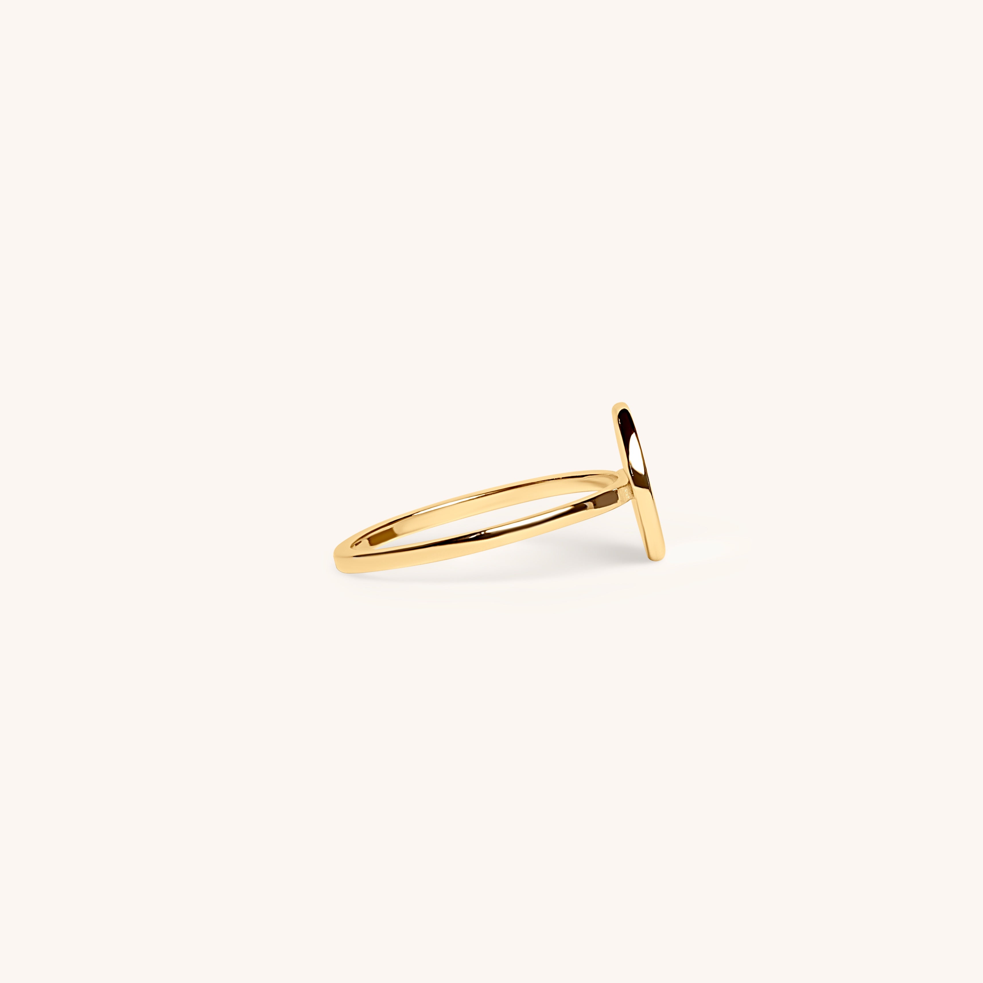 PS46 Jewelry Selah 14K gold ring with thin band and disc side view displayed on an off-white background.