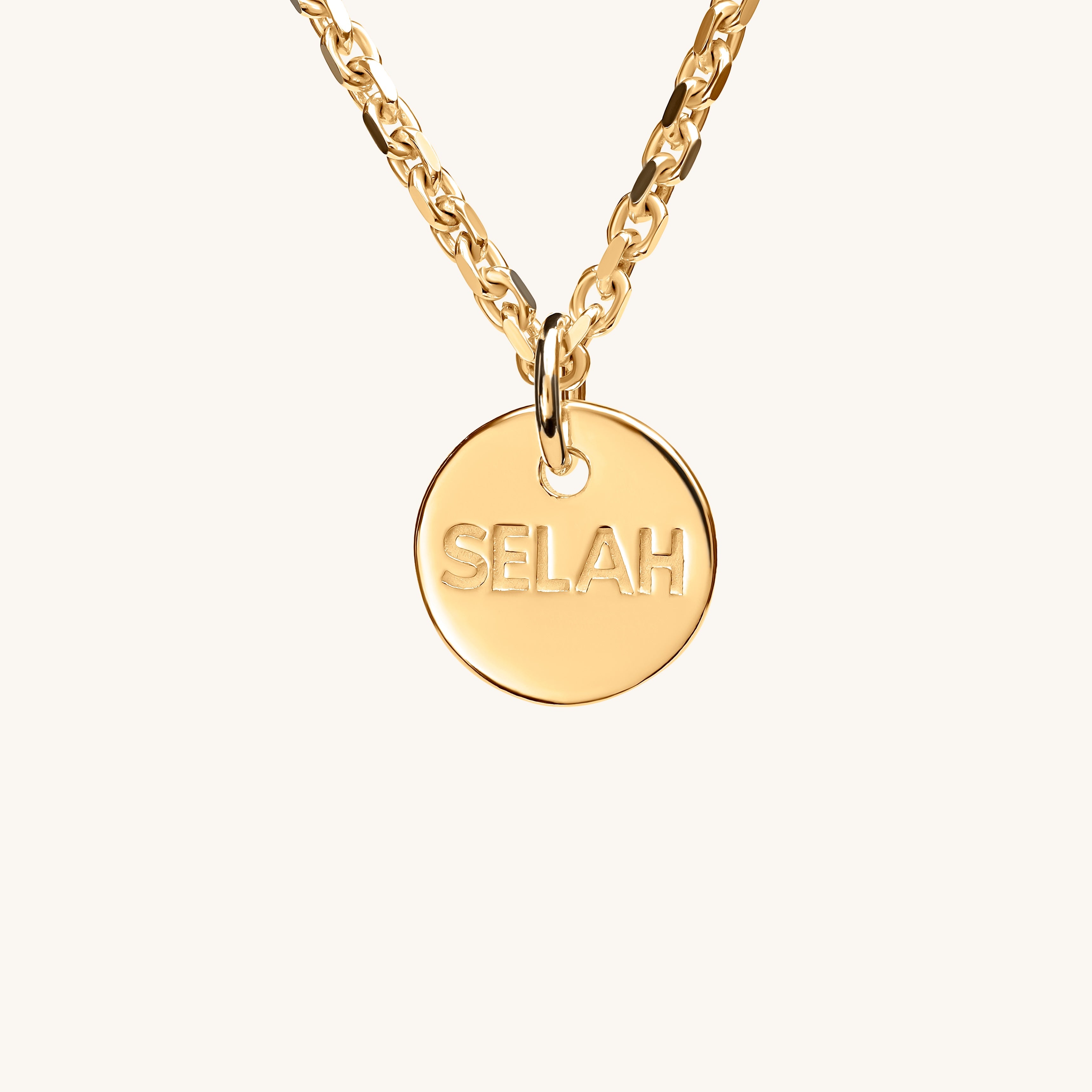 PS46 Jewelry Selah 18K gold necklace with 'SELAH' pendant displayed on an off-white background.