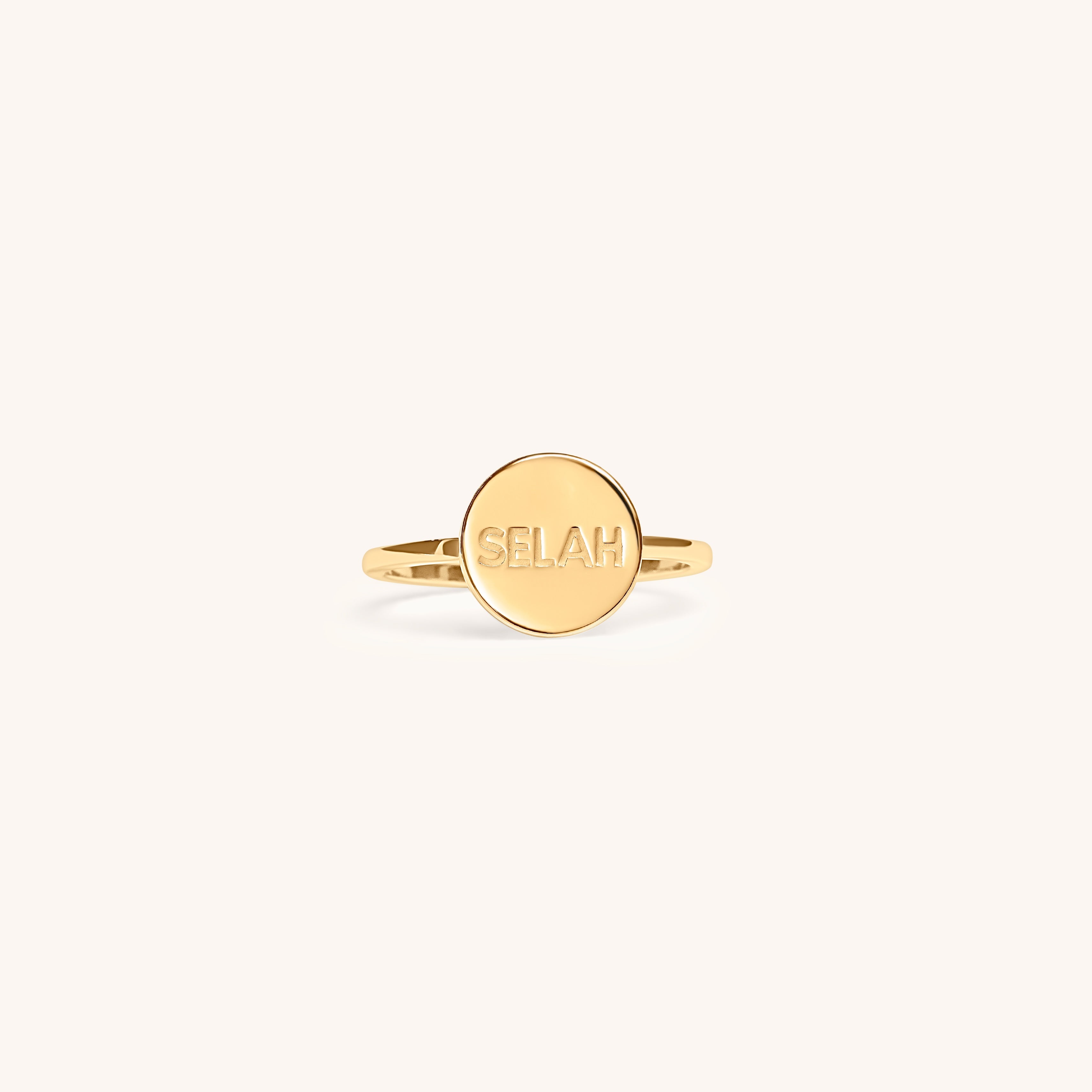 PS46 Jewelry Selah 14K gold ring with 'Selah' engraving displayed on an off-white background.